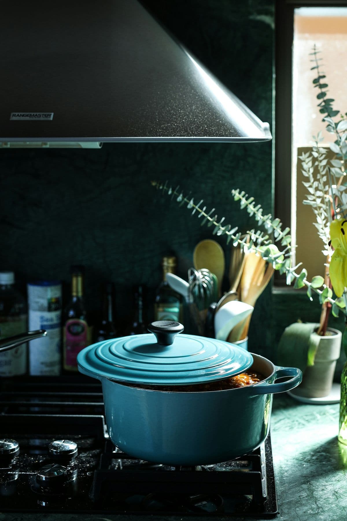 Le Creuset pot simmering on the stove — batch cooking freezer meals on a budget