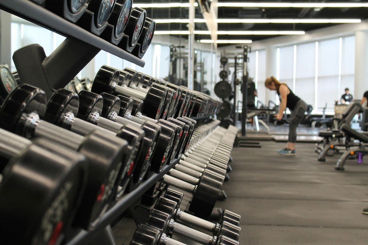 Rows of dumbbells on a gym rack — staying fit while working long hours