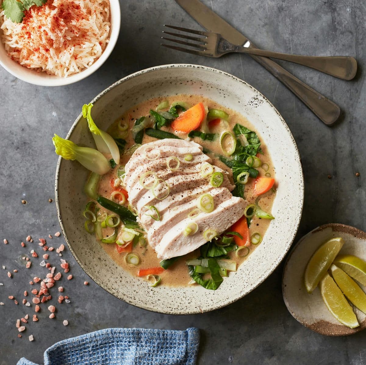 Sliced chicken breast in coconut curry with rice and vegetables — quick one-pot dinner