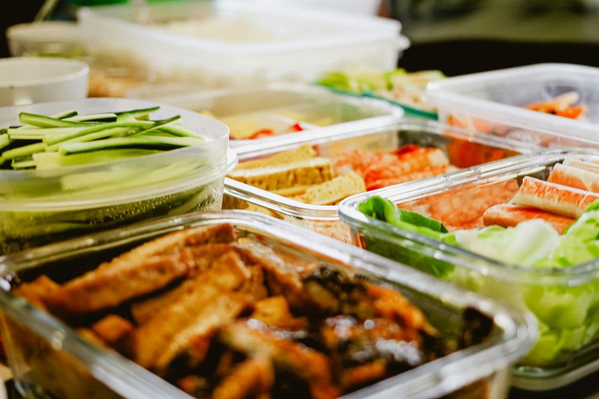 Glass meal prep containers filled with prepped vegetables and protein ready for night shift meals